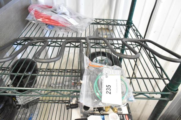 Metal burner with coiled design on wire rack, includes tag reading "235, QTY 1, PCAuctions.com"; new condition.