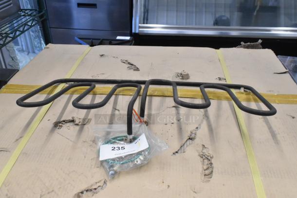 Metal burner with multiple coils, displayed on cardboard. Item tag number 235. Includes connected wires and screws in a bag.