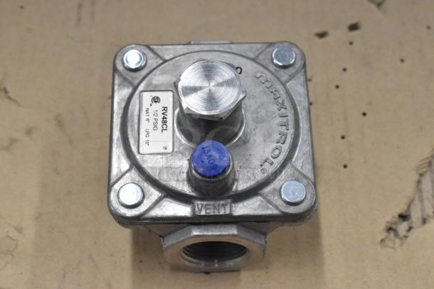 Brand new Dormont RV48CL gas regulator, metal, with label showing model and specifications, slight scratch and dent condition.