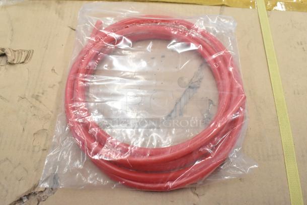 Red coiled hose in clear plastic packaging, unopened. Part of a lot including Dormont RV48CL Gas Regulator, new condition.