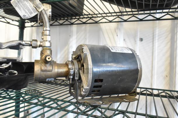 Marathon 5KH32GNB811BX Motor, 100-120/200-240V, 1 Phase, on shelf. Includes attached metal fittings and visible label.