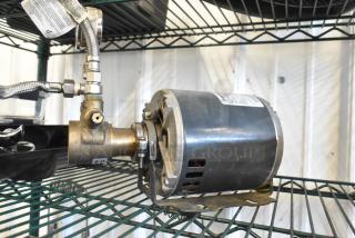 Marathon 5KH32GNB811BX Motor, 100-120/200-240V, 1 Phase, on shelf. Includes attached metal fittings and visible label.