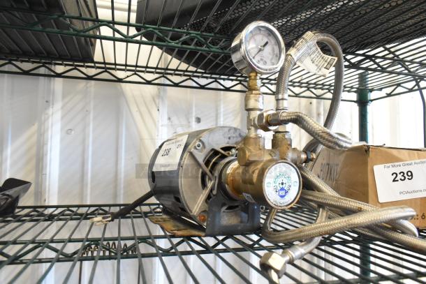 Marathon 5KH32GNB811BX Motor on shelf, 100-120/200-240 Volts, 1 Phase, with attached pressure gauge and braided hoses.