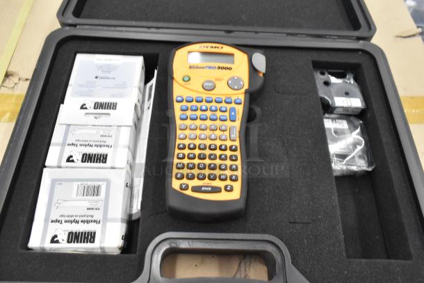 Dymo RhinoPro 5000 label printer in hard case with accessories. Includes extra labels. Ideal for industrial use.