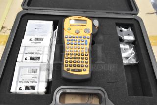 Dymo RhinoPro 5000 label printer in hard case with accessories. Includes extra labels. Ideal for industrial use.