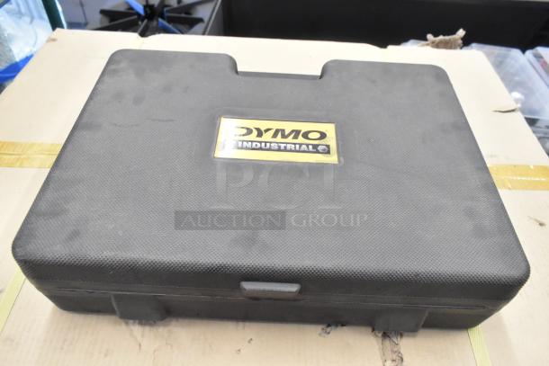 Dymo RhinoPro 5000 label printer in black hard case with Dymo Industrial logo, case shows slight wear.