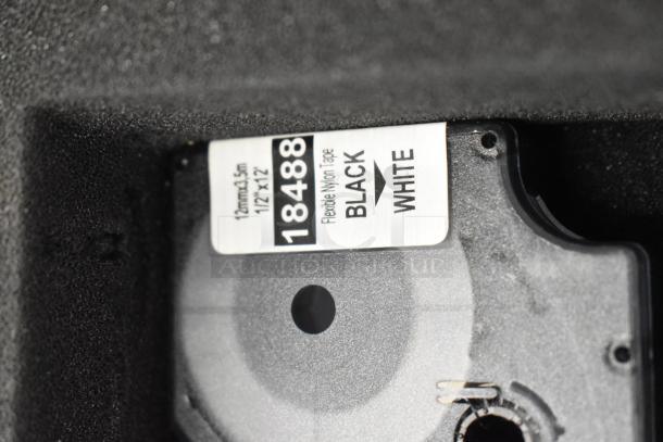 Dymo RhinoPro 5000 Label Printer, features a tape label marked "18488 Black on White," in protective hard case.