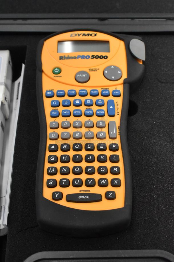 Dymo RhinoPro 5000 label printer in hard case, features full keypad and LCD. Good condition.