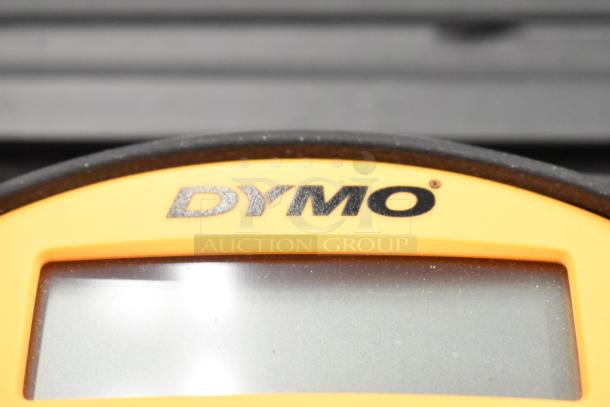 Dymo RhinoPro 5000 label printer with visible display, encased in protective hard case. Brand logo prominently displayed.