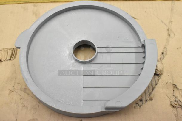 Food processor slicing blade, gray, plastic, marked with "F 10," in good condition. Includes S blade and three other items.