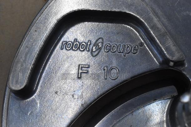 Robot Coupe slicing blade with "F 10" marking, stainless steel, compatible with food processors, in good condition.