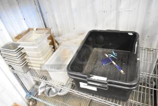 Auction tier lot including black bus bins, stackable transparent drop-in bins on metal shelving, various kitchen items, good condition.
