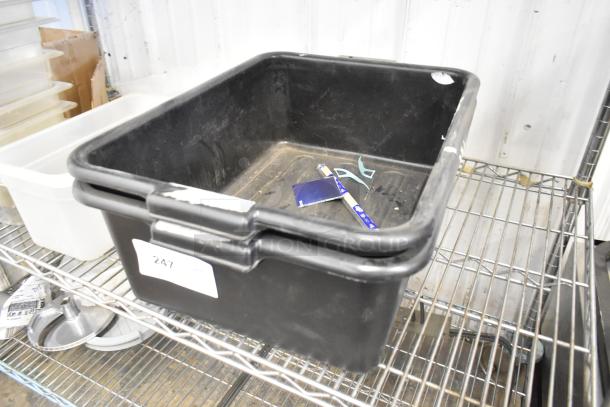 Black bus bin on metal shelf with label "247", includes drop-in bins, minor wear visible, practical for storage.