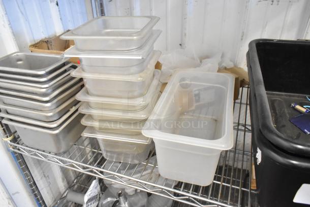 Tiered lot of black bus bins and clear drop-in bins on metal shelving. Used condition, ideal for storage and organization.