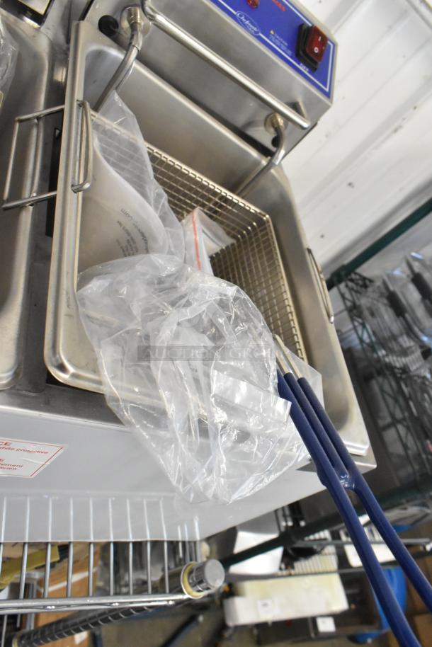 Brand new Globe PF32E stainless steel countertop fryer with 2 metal fry baskets, 208-240V, 1 phase, scratch and dent condition.