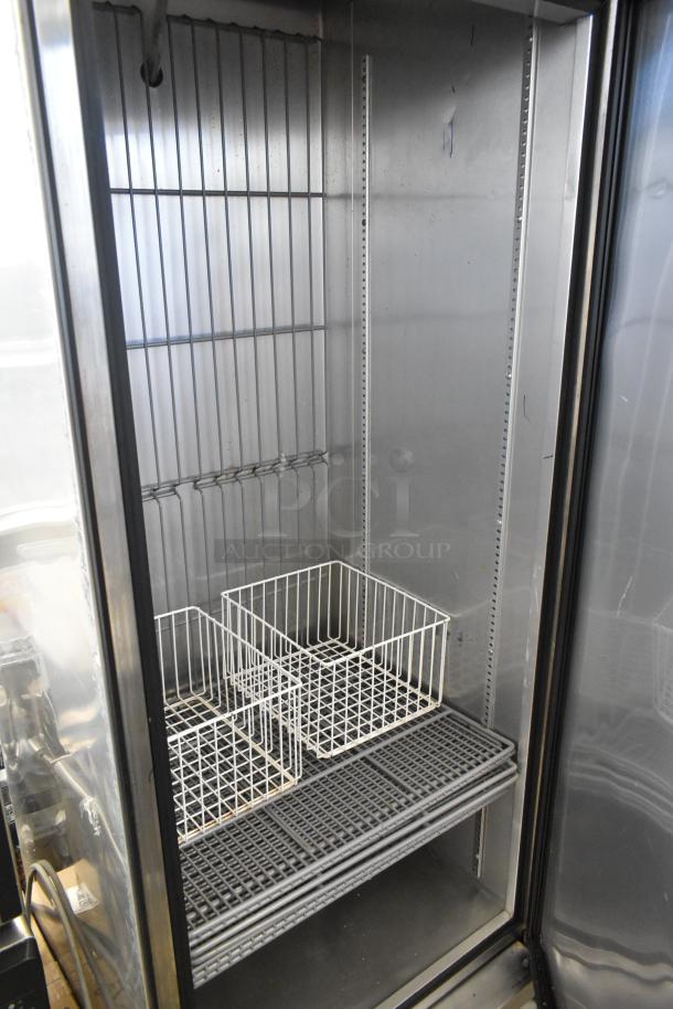 2017 True T-19F stainless steel commercial single door reach-in freezer, interior view, with wire shelves and baskets.
