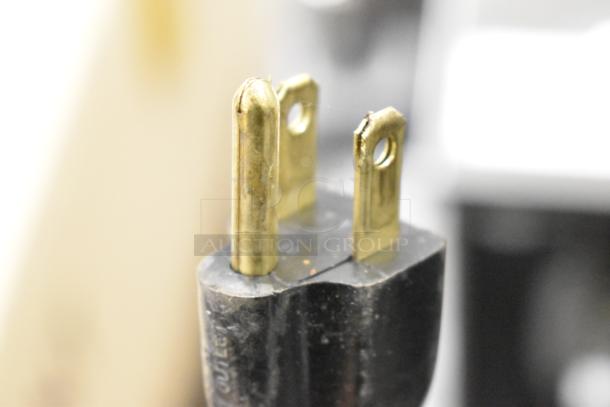 A close-up of a three-prong plug for the Vollrath JT1 conveyor toaster oven, suitable for 120V, 1-phase outlets.