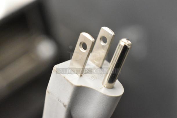 Close-up image of a power plug from a 2021 Amana RMS10DSA commercial microwave oven.