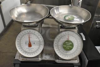 Two Yamato SM(N) metal countertop food portioning scales, analog dials, stainless steel trays, labels indicate "approximation only."