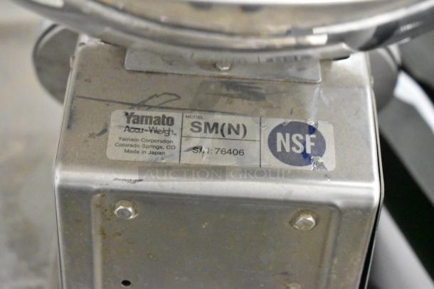 Two Yamato SM(N) metal countertop food portioning scales with NSF label. Model details visible, showing signs of wear.