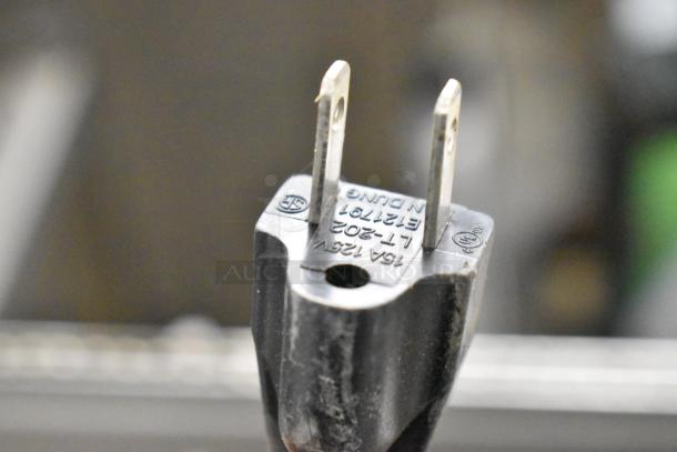 Close-up of a plug for the 2021 Cadco Unox XAF003 Roberta convection oven, showing 125V, ETL-listed markings.