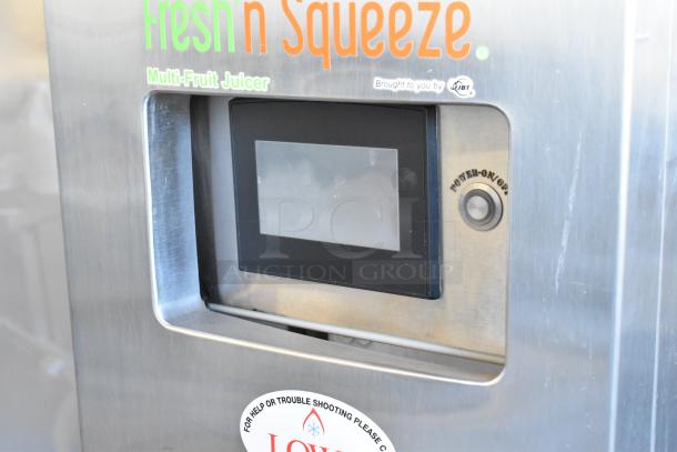 JBT Fresh N Squeeze 2ND-GEN-MFJ stainless steel commercial citrus juicer with touchscreen, power button, on commercial casters.
