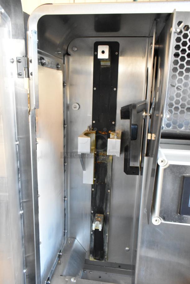 JBT Fresh N Squeeze 2ND-GEN-MFJ stainless steel citrus juicer interior, commercial casters, 120 volts, 1 phase.