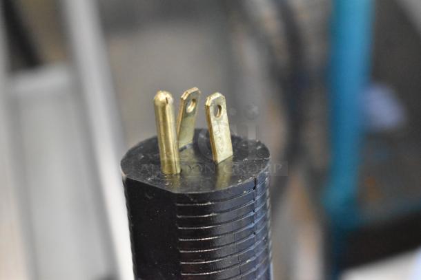 Close-up of a three-prong plug from the JBT Fresh N Squeeze 2ND-GEN-MFJ citrus juicer, showing its electrical connector.