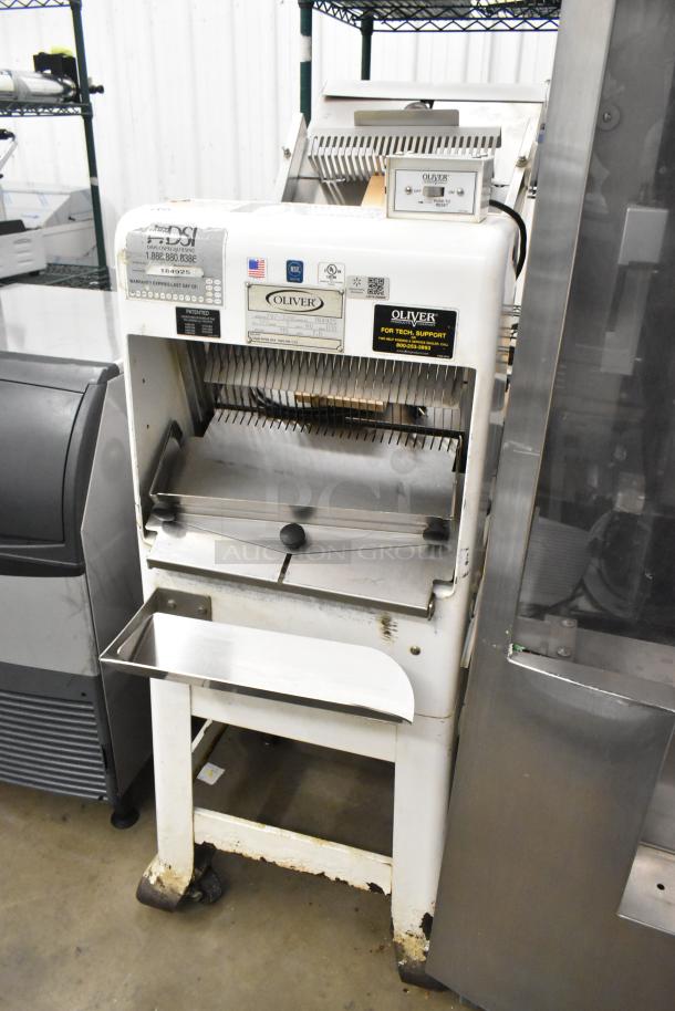 Oliver 797-32NC metal bread loaf slicer on casters, 115V, 1 phase. Features labels and gauges. Used condition.