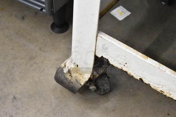 Oliver 797-32NC Metal Bread Slicer on casters; shows visible rust and wear, highlighting commercial use.