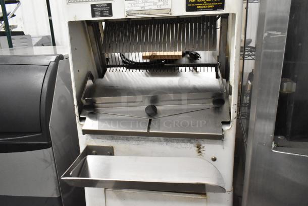 Oliver 797-32NC metal commercial bread loaf slicer on casters, 115 volts, 1 phase. Features visible blades and crumb tray.