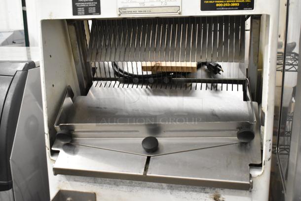 Oliver 797-32NC bread slicer, commercial floor model on casters, metal with visible slicing blades, operates at 115 volts, 1 phase.
