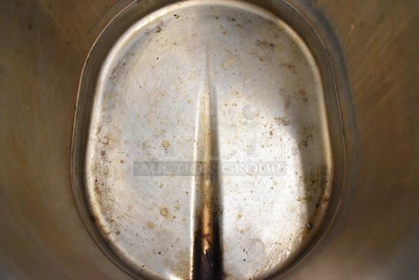 Bunn TDO stainless steel beverage dispenser interior, showing wear and staining. Model TDO, suitable for countertops.