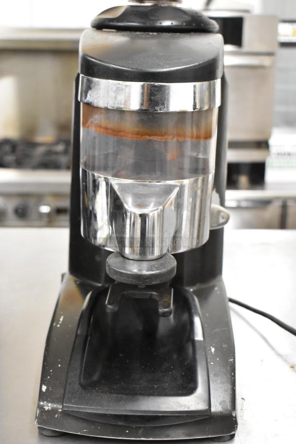 Metal commercial countertop espresso bean grinder, black and silver, 115 volts, 1 phase, visible wear on exterior.