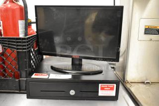 Revo monitor on metal cash drawer. Visible wear on screen. Labels on drawer for security instructions.