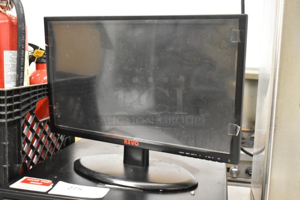 Revo monitor with metal cash drawer, featuring a black frame and base. Visible brand label on the front. Condition appears used.