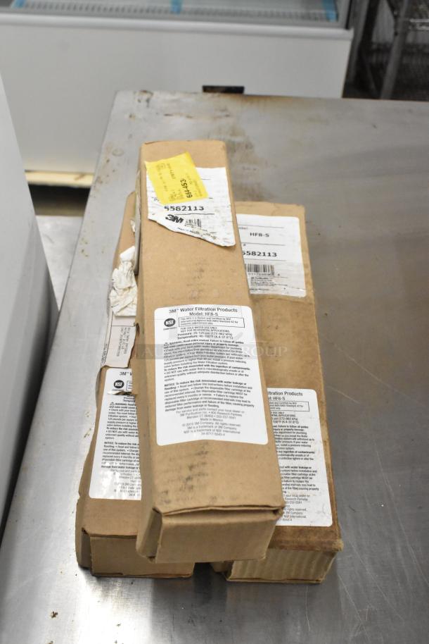 Assorted new items including 3M SW-SR-60 cartridges and HF8-S water filters, in boxes with labeled specifications.