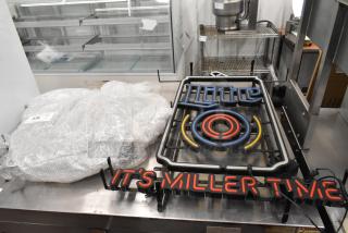 Two neon signs: "It's Miller Time" in red and a Rolling Rock design. Signs are bubble-wrapped, pick-up only.