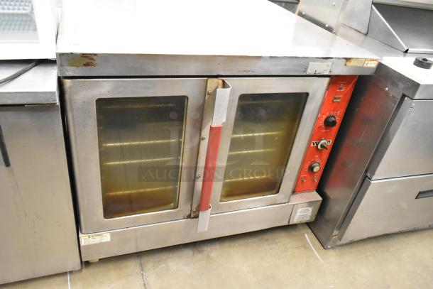 Vulcan stainless steel commercial full-size convection oven with view-through doors, metal racks, and thermostatic controls.