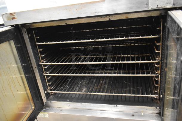 Vulcan stainless steel commercial convection oven with view-through doors, metal racks, and thermostatic controls. Used condition.