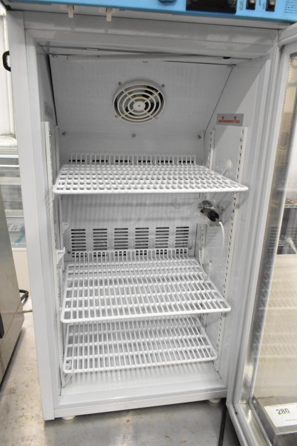 2019 Accucold ARG3PV mini cooler merchandiser, metal shelves, 115V, 1 Phase, clean interior, fan visible.