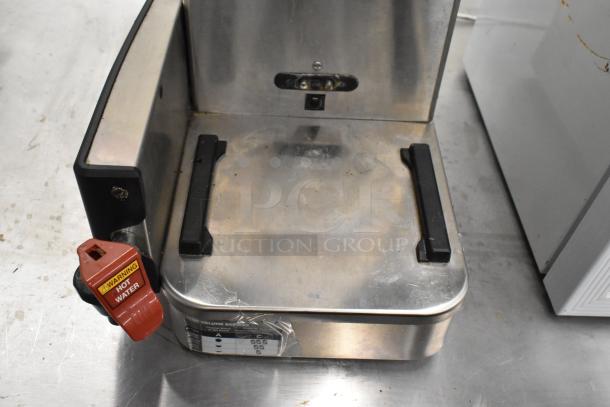 2020 Bunn ICB SH stainless steel iced tea machine with hot water dispenser, showing brew basket area. Some wear visible.