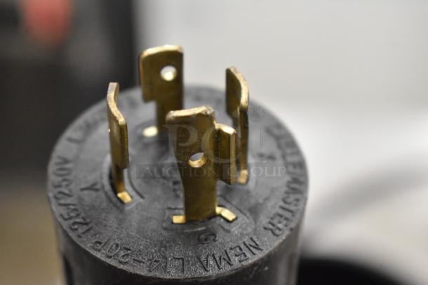 Close-up of a 120/208 Volt electrical plug on a 2020 Bunn ICB SH stainless steel iced tea machine, showing prongs and markings.