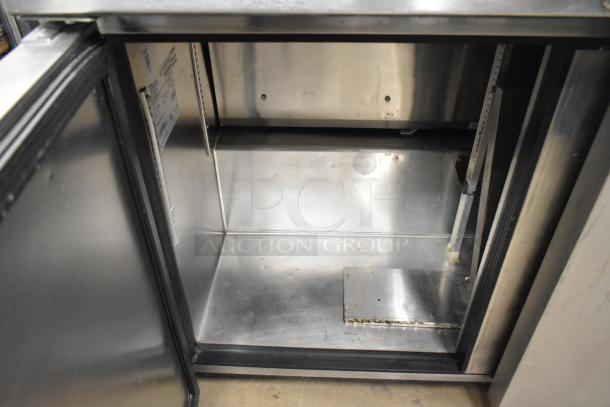 True TUC-48F-LP stainless steel undercounter freezer, 2 doors open, interior view, 115V, 1 Phase, sturdy build, commercial use.