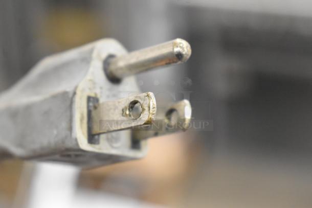 Close-up of the plug for a 2018 Bizerba GSP HD Meat Slicer, showing a well-used electrical prong detail.