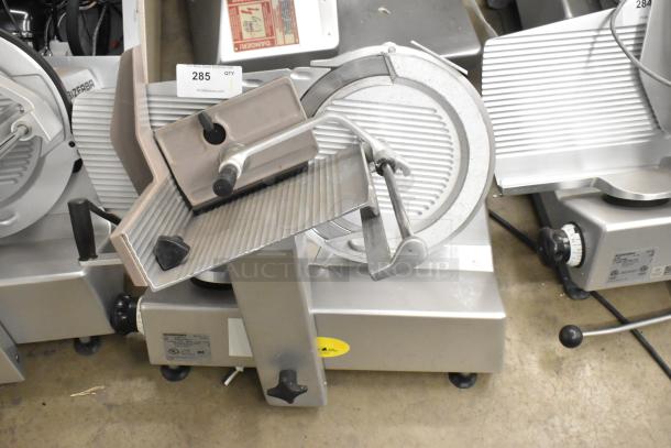 Bizerba SE 12 US commercial meat slicer, metal, 120 volts, one phase, countertop design, auction tag visible.