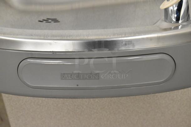 Brand new Elkay EZSTLDWS_1G stainless steel wall mount water fountain, 115V, 1 Phase, with "Elkay" label. Minor scratches.