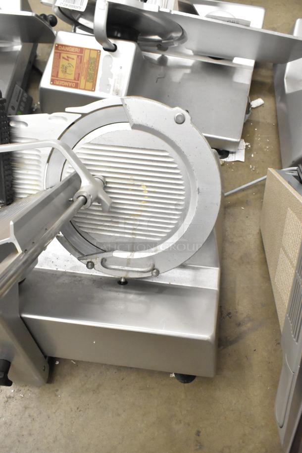 Bizerba SE 12 US metal commercial meat slicer, 120V, 1 phase. Visible wear, safety labels present. Countertop model.