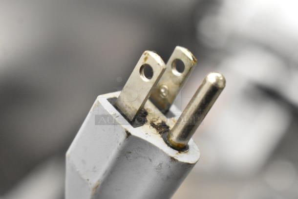 Three-prong plug for Bizerba SE 12 US commercial meat slicer, 120 Volts, 1 Phase. Close-up shows slight wear.