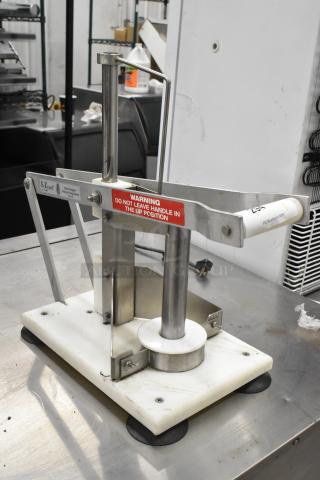 E-Z Cut II Metal Countertop Pineapple Corer with white base, stainless steel parts, and safety warning label. Good condition.